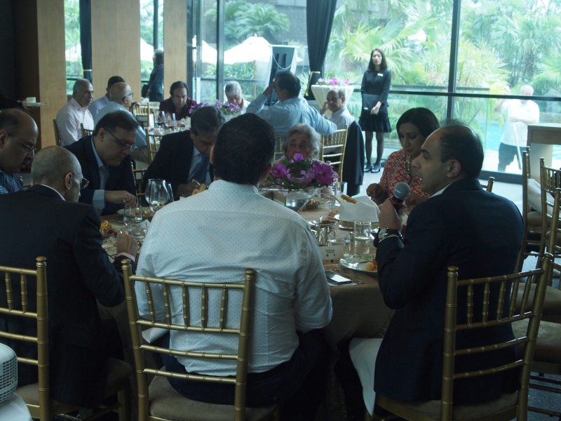 man asks question while seated at table