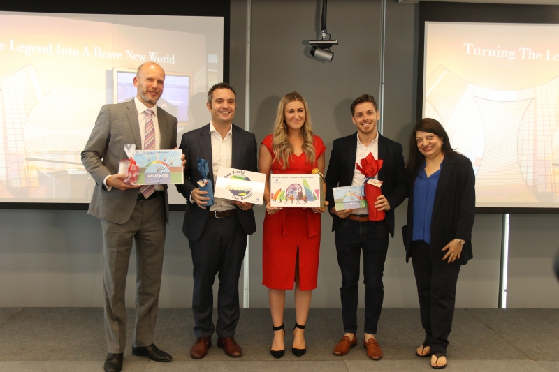 women and men stand holding certificates and awards