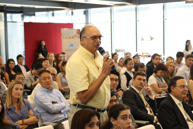man in yellow shirt asks question from seated audience