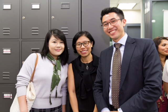 2 women and a man in business attire are grouped together for a photo