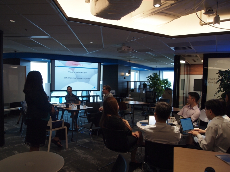 Training participants in business attires are having a group discussion while seated at a table