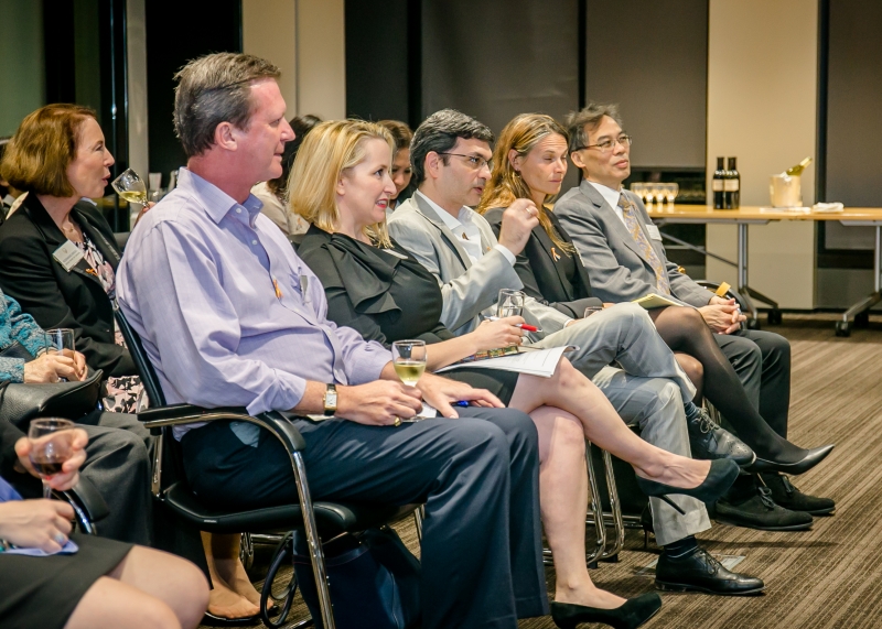 A group of men and women in business attire sitting on chairs