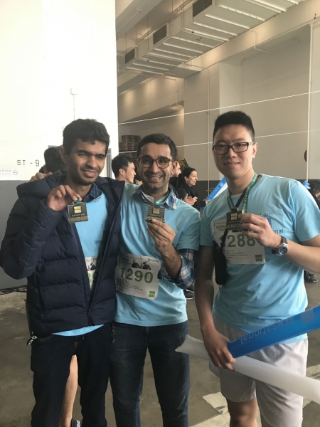 three men pose smiling
