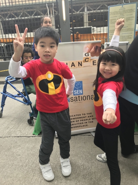 two children pose in red tshirts