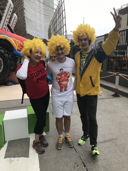 three people in yellow wigs pose