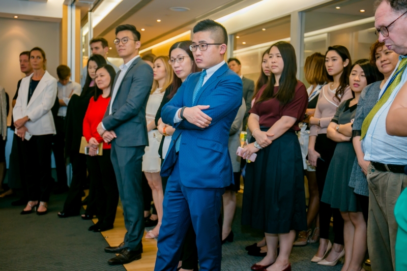 Colliers staff members in business attire are paying attention to the panel discussion