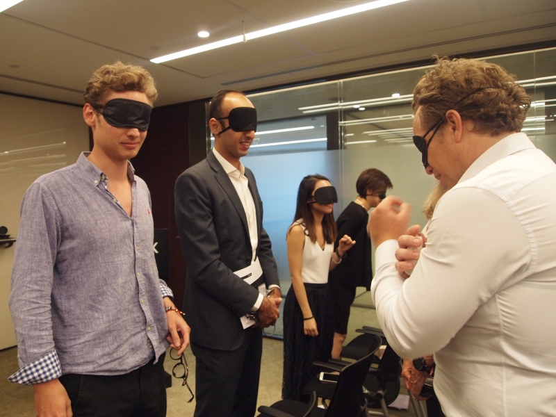standing blindfolded participants turn around to introduce themselves to each other