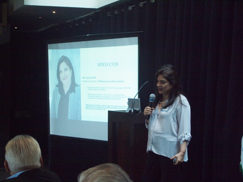 woman presents in front of screen